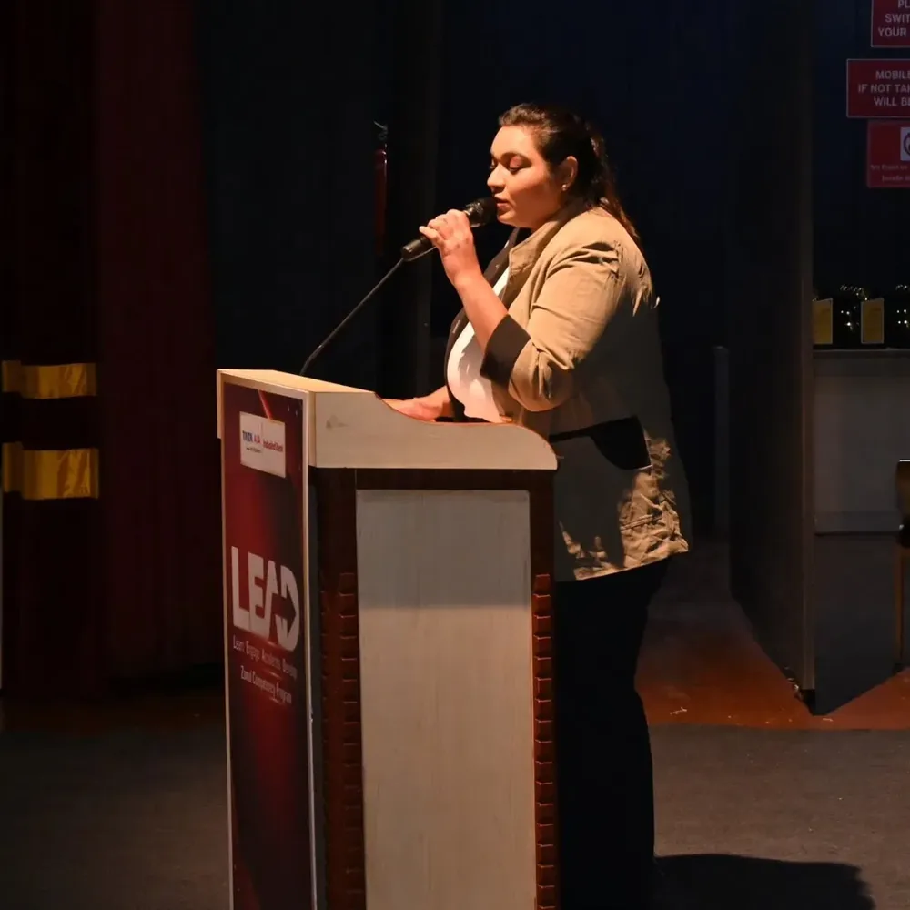 Corporate emcee in Pune hosting from a podium — Aanchor Ritzzu